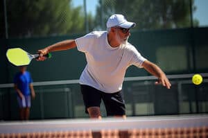 Active older gentleman playing pickleball