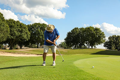 Gentleman in shorts golfing on Longboat Key