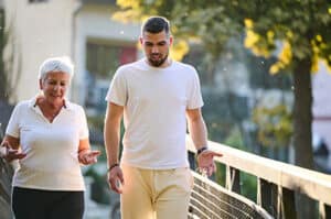 Mother and grown son walking through the neighborhood