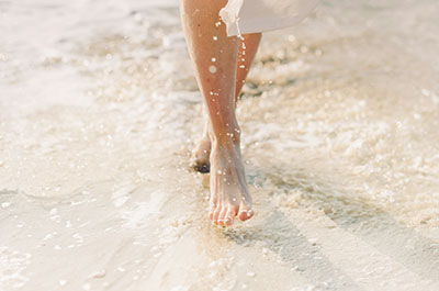 Woman walking on the white sand of Siesta Key Beach